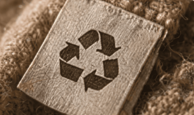 Recycling symbol on wood and burlap